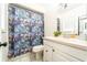 Clean bathroom featuring a colorful fish-themed shower curtain and white vanity at 1413 La Paloma Cir, Winter Springs, FL 32708