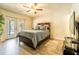 Bright bedroom with hardwood floors, a ceiling fan, and access to the pool at 1413 La Paloma Cir, Winter Springs, FL 32708