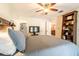 Cozy bedroom featuring a comfortable queen-size bed, ceiling fan, and closet at 1413 La Paloma Cir, Winter Springs, FL 32708