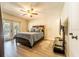 Bright bedroom with hardwood floors, a ceiling fan, and access to the pool at 1413 La Paloma Cir, Winter Springs, FL 32708