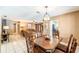 Open dining room with wood table and view to living room, bathed in warm natural light at 1413 La Paloma Cir, Winter Springs, FL 32708