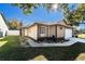 Tan house with white garage door, landscaped lawn, and walkway at 1413 La Paloma Cir, Winter Springs, FL 32708