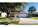 Single story home with attached garage and mature landscaping at 1413 La Paloma Cir, Winter Springs, FL 32708