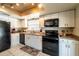 Bright kitchen with white cabinets, black appliances, and tile flooring at 1413 La Paloma Cir, Winter Springs, FL 32708