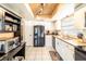 Kitchen with white cabinets, black appliances and pantry at 1413 La Paloma Cir, Winter Springs, FL 32708
