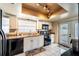 Kitchen with white cabinets, black appliances, and a door to outside at 1413 La Paloma Cir, Winter Springs, FL 32708