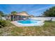 A bright, blue pool is surrounded by brick pavers and a white privacy fence with screened in patio area at 1413 La Paloma Cir, Winter Springs, FL 32708