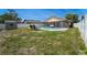 A bright, blue pool is surrounded by brick pavers and a white privacy fence with lounge chairs nearby at 1413 La Paloma Cir, Winter Springs, FL 32708