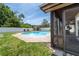Backyard pool features a brick paver deck, a shed and is surrounded by a white privacy fence at 1413 La Paloma Cir, Winter Springs, FL 32708