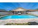 A bright, blue pool is surrounded by brick pavers and a white privacy fence with screened in patio area at 1413 La Paloma Cir, Winter Springs, FL 32708