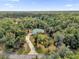 Aerial view of house nestled in a wooded lot at 1908 S Farm Rd, Deland, FL 32720