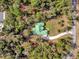 An aerial shot of a house featuring a large green roof and a long driveway at 1908 S Farm Rd, Deland, FL 32720