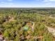 Aerial view of a house with a green roof in a wooded area at 1908 S Farm Rd, Deland, FL 32720