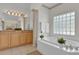 Bright bathroom with double vanity and soaking tub at 1908 S Farm Rd, Deland, FL 32720