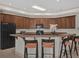 Kitchen with large island, granite countertops, and dark wood cabinets at 1908 S Farm Rd, Deland, FL 32720