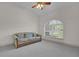 Living room with large window, ceiling fan, and comfortable sofa at 1908 S Farm Rd, Deland, FL 32720