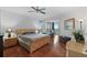 Primary bedroom with wood floors, king bed, and balcony access at 1925 S Atlantic Ave # 703, Daytona Beach, FL 32118