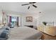 Primary bedroom with king-size bed, wood floors, and private balcony at 1925 S Atlantic Ave # 703, Daytona Beach, FL 32118
