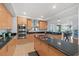 Modern kitchen with island, light wood cabinets, and granite countertops at 1925 S Atlantic Ave # 703, Daytona Beach, FL 32118