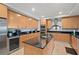 Spacious kitchen featuring stainless steel appliances and an island with seating at 1925 S Atlantic Ave # 703, Daytona Beach, FL 32118