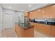 Modern kitchen with island, light wood cabinets, and granite countertops at 1925 S Atlantic Ave # 703, Daytona Beach, FL 32118