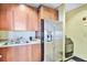 Common area kitchen with stainless steel appliances and wood cabinets at 1925 S Atlantic Ave # 703, Daytona Beach, FL 32118