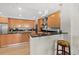 Modern kitchen with light wood cabinets, granite counters, and stainless steel appliances at 1925 S Atlantic Ave # 703, Daytona Beach, FL 32118