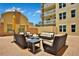 Outdoor seating area with wicker furniture and yellow umbrella at 1925 S Atlantic Ave # 703, Daytona Beach, FL 32118