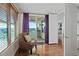 Cozy sitting area with comfy chair and access to balcony at 1925 S Atlantic Ave # 703, Daytona Beach, FL 32118