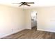Spacious bedroom with wood-look flooring and access to bathroom at 222 Oak Branch Dr, Edgewater, FL 32141