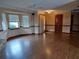 Living room with hardwood floors, brick fireplace, and lots of natural light at 2230 Vance Rd, Deltona, FL 32738