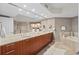 Elegant bathroom with double vanity, soaking tub, and walk-in shower at 231 Riverside Dr # 1001, Holly Hill, FL 32117