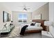 Modern bedroom with large window, ceiling fan and wood platform bed at 231 Riverside Dr # 1001, Holly Hill, FL 32117