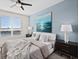 Spacious bedroom with large window, modern decor, and ceiling fan at 231 Riverside Dr # 1001, Holly Hill, FL 32117
