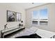 Well-lit bedroom with window, modern art and media console at 231 Riverside Dr # 1001, Holly Hill, FL 32117