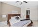Bright bedroom with a wooden platform bed, nightstands, and access to the bathroom at 231 Riverside Dr # 1001, Holly Hill, FL 32117