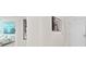 Bright hallway with artwork and view into bedroom at 231 Riverside Dr # 1001, Holly Hill, FL 32117