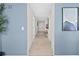 Clean hallway with light blue walls and artwork at 231 Riverside Dr # 1001, Holly Hill, FL 32117