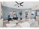 Living room featuring a world map artwork and ceiling fan at 231 Riverside Dr # 1001, Holly Hill, FL 32117