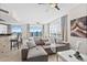 Living room with sectional sofa, water views and access to kitchen and balcony at 231 Riverside Dr # 1001, Holly Hill, FL 32117