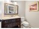 Clean bathroom with a single vanity, toilet, and framed mirror at 235 Pine Cone Trl, Ormond Beach, FL 32174