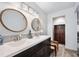 Modern bathroom with double vanity, large mirrors, and a separate shower at 235 Pine Cone Trl, Ormond Beach, FL 32174