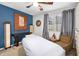 Relaxing bedroom with massage table, blue accent wall, and built-in shelving at 235 Pine Cone Trl, Ormond Beach, FL 32174
