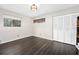 Spacious bedroom with dark laminate floors and built-in closet at 235 Pine Cone Trl, Ormond Beach, FL 32174