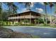 Two story community building with wrap around porch at 235 Pine Cone Trl, Ormond Beach, FL 32174