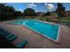 Inviting community pool with ample lounge chairs at 235 Pine Cone Trl, Ormond Beach, FL 32174