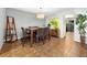 Dining area with tile floors and a wooden table with brown leather chairs at 235 Pine Cone Trl, Ormond Beach, FL 32174
