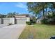Exterior view of townhouse, showing garage and landscaping at 235 Pine Cone Trl, Ormond Beach, FL 32174