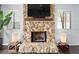 Stone fireplace with a large flatscreen TV above at 235 Pine Cone Trl, Ormond Beach, FL 32174