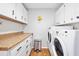 Bright laundry room with washer, dryer, and ample cabinetry at 235 Pine Cone Trl, Ormond Beach, FL 32174